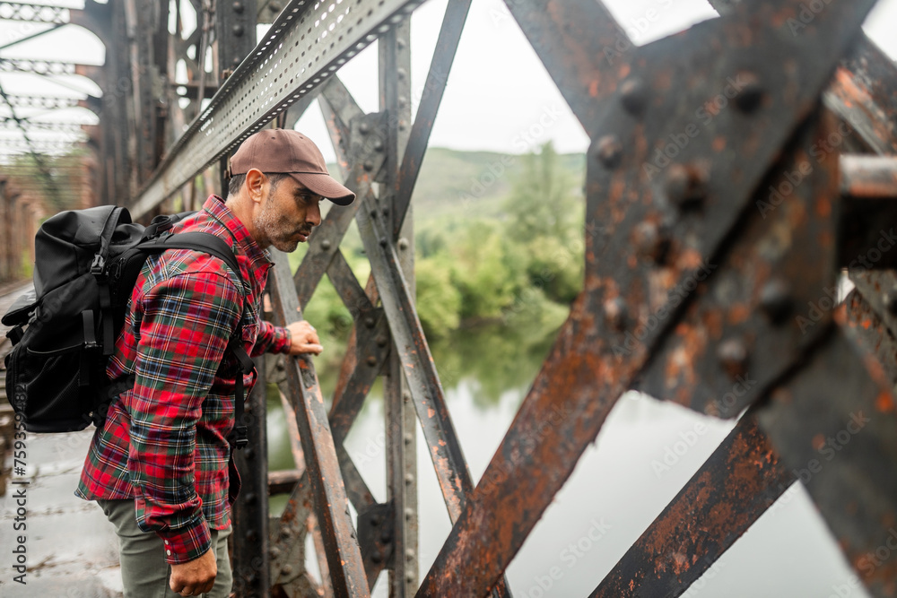 man exploring old train tracks in nature man exploring old train tracks in nature