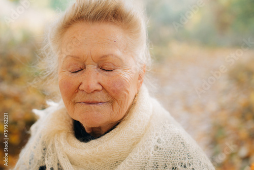 Close up of elder woman with closed eyes photo