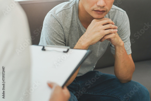 asian man talking with psychologist and checking symptom of mental health. photo