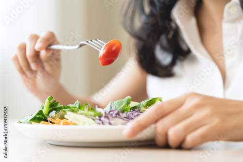 Diet, Dieting asian young woman or girl use fork at broccoli on mix vegetables, green salad bowl, eat food is low fat good health. Nutritionist female, Weight loss for healthy person.