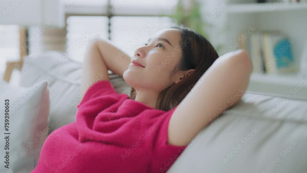 Relaxed young Asian woman enjoying rest on comfortable sofa, calm attractive girl relaxing on couch, breathing fresh air with eyes closed, meditating at home Relaxed young Asian woman enjoying rest on comfortable sofa, calm attractive girl relaxing on couch, breathing fresh air with eyes closed, meditating at home