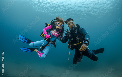 child scuba diver and adult diver go diving (ID: 759411621)