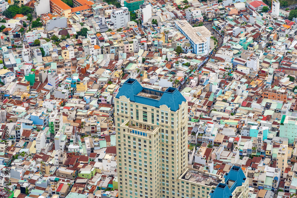 Aerial view of a skyscraper amongst tightly packed coloured buildings at Ho Chi Mihn City in Vietnam