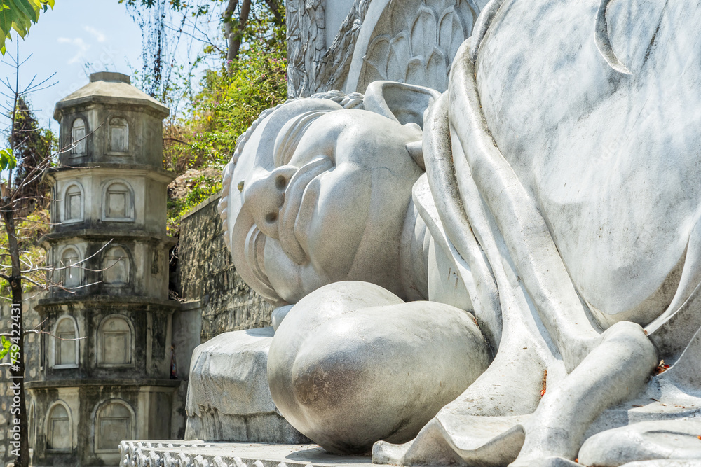 Close up view of a large stone statue of buddha laying on its side at Nha Trang in Vietnam Close up view of a large stone statue of buddha laying on its side at Nha Trang in Vietnam