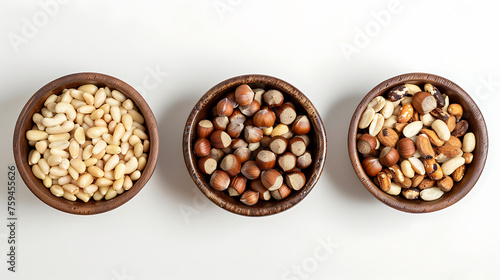 Mix of nuts in wooden bowls on white background. Top view.
