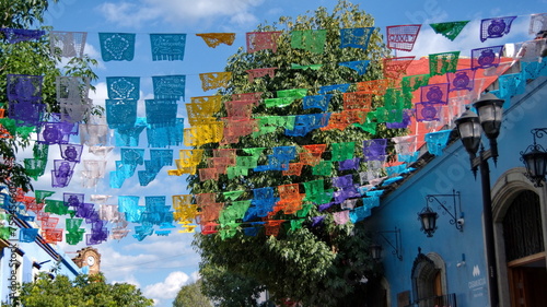 Colorful Day of the Dead flags hanging above the street in Oaxaca, Mexico © Angela
