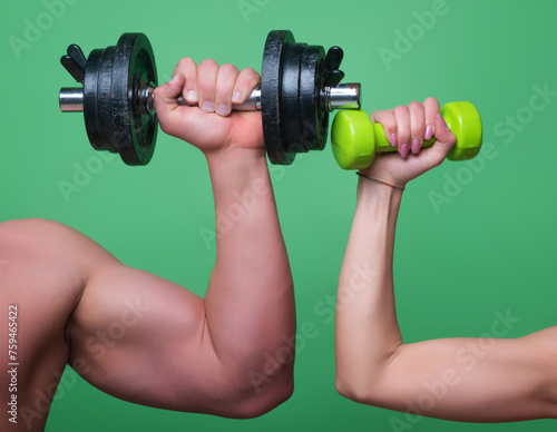 Male and female hands with dumbbells close-up. Training muscles. Female and male hand holds dumbbell. Muscular hands, exercises with dumbbells. Strong muscles. Dumbbell isolated. Fitness and Sport.