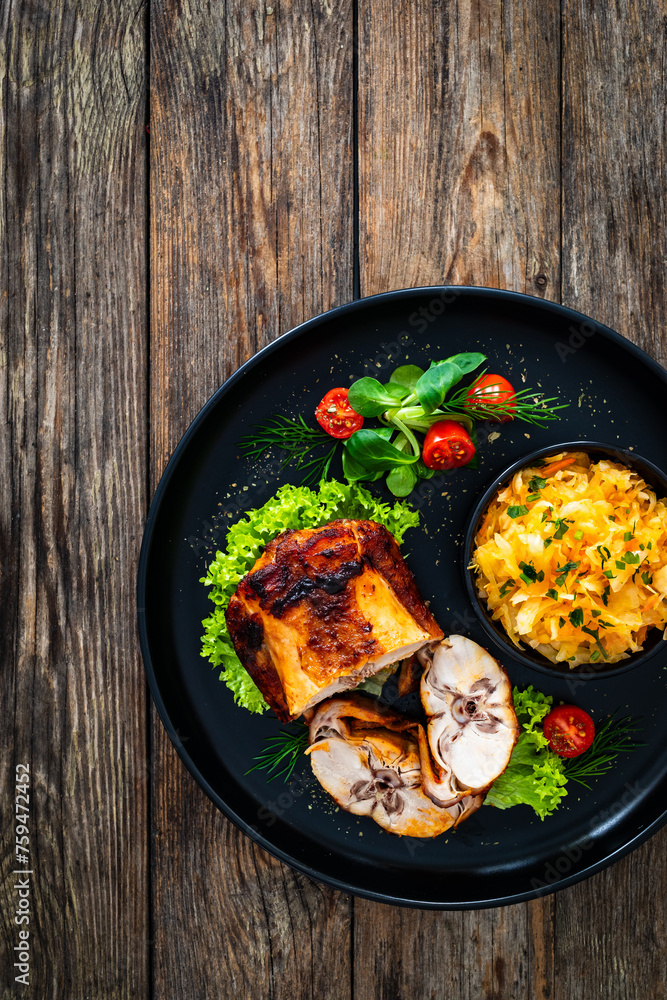 Baked rabbit saddle and vegetable salad on wooden table
Baked rabbit saddle and vegetable salad on wooden table