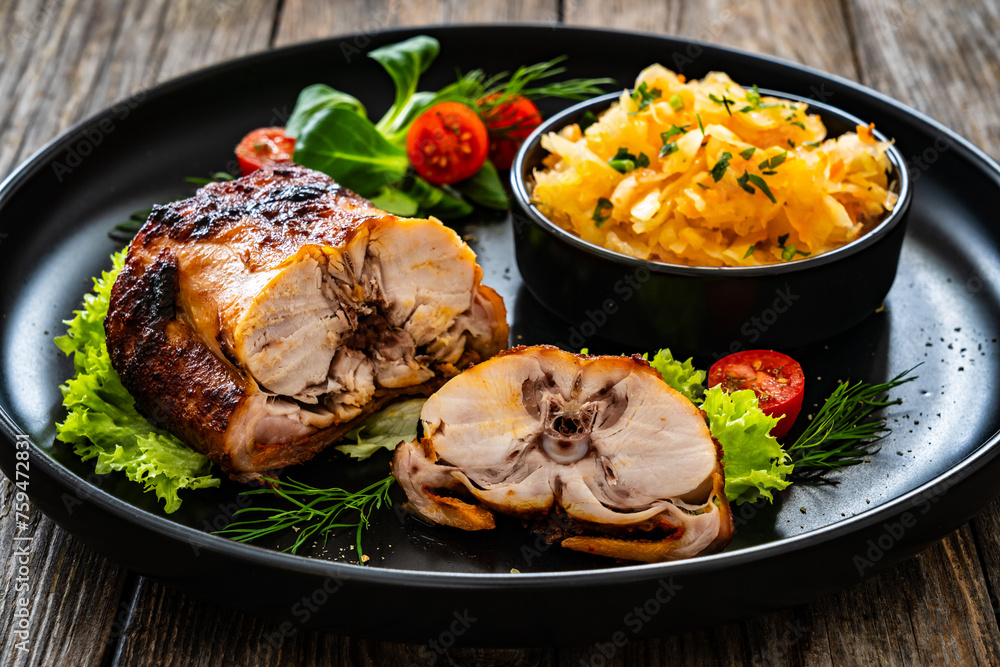 Baked rabbit saddle and vegetable salad on wooden table
Baked rabbit saddle and vegetable salad on wooden table