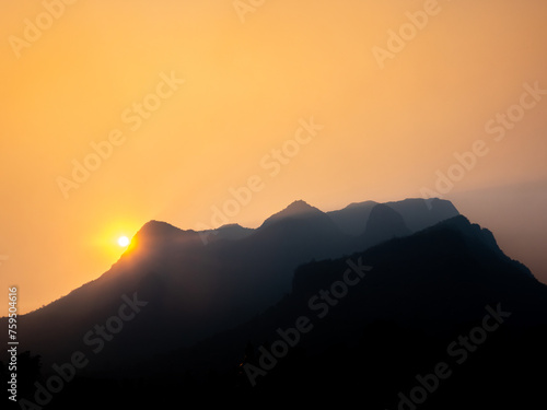 Sun Shines Golden Light on The Silhouette Mountain photo