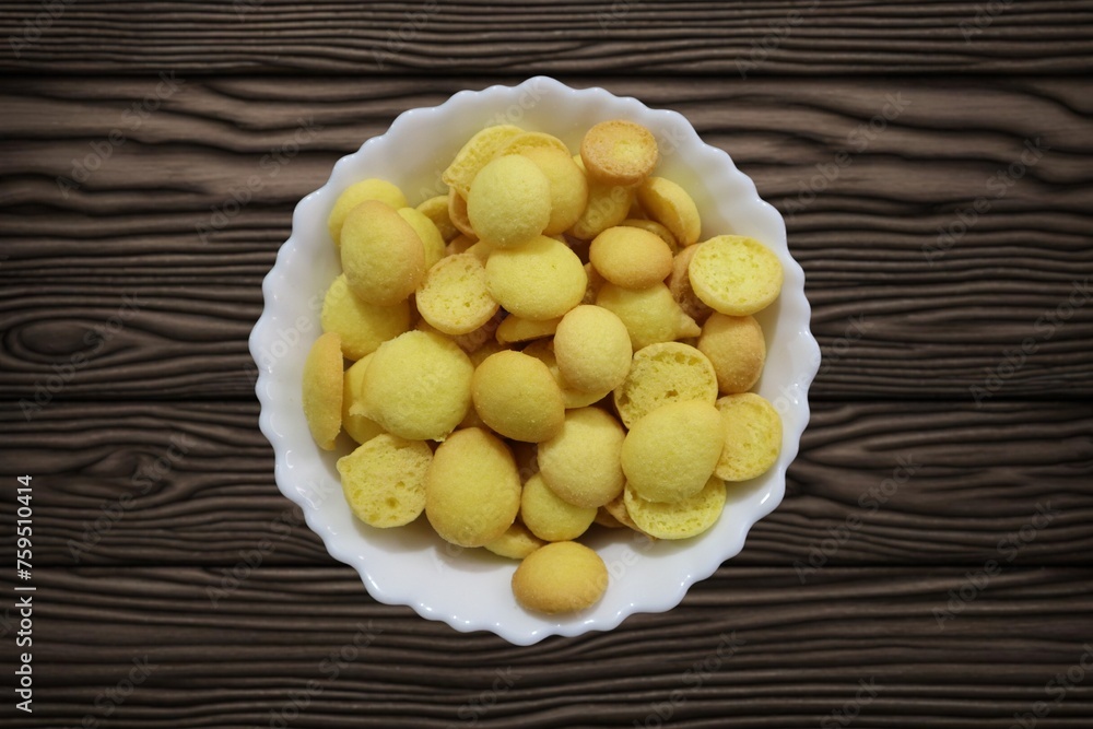 Known as egg biscuits, these Special Kerala Mutta biscuits are also known as Beans biscuits, Coin biscuits, Yellow Biscuits, Baby Biscuits, and Orange and Yellow Crunchy Beans Cookies.