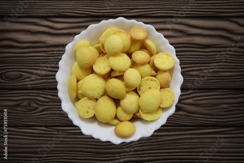 Known as egg biscuits, these Special Kerala Mutta biscuits are also known as Beans biscuits, Coin biscuits, Yellow Biscuits, Baby Biscuits, and Orange and Yellow Crunchy Beans Cookies. photo