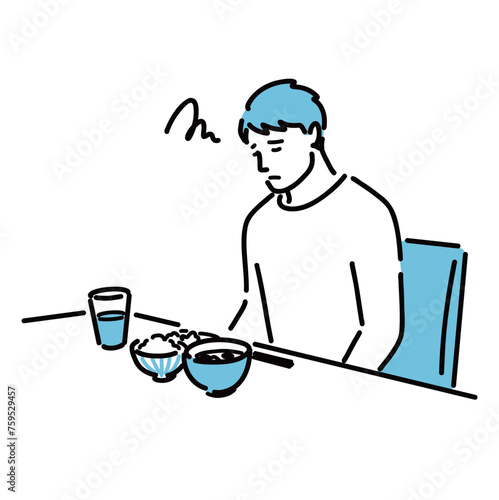 食欲不振に悩んでいる若い男性
