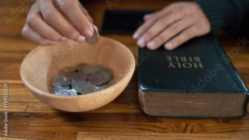 Close up hands people church congregants placing Money on an offering basket. photo