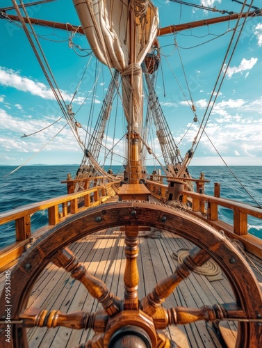View from the helm to the deck from behind the vertical wheel of a ship on an old pirate sailboat on the high seas on a sunny day. concept sea, ships, vintage, cinematic, helm
