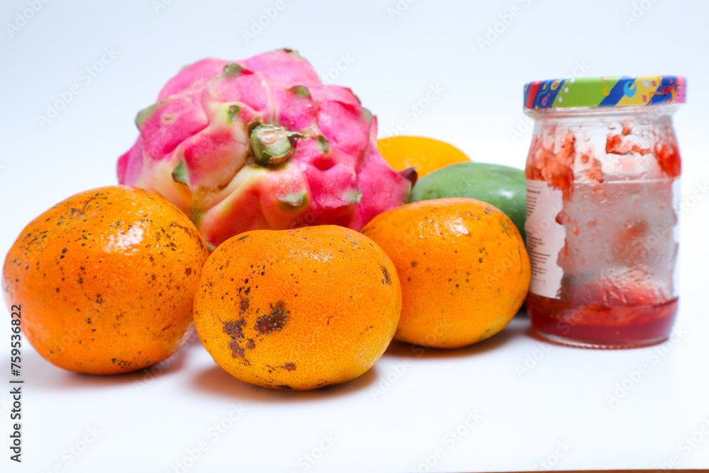 tropical fruit and a jar of jam isolated on a white background