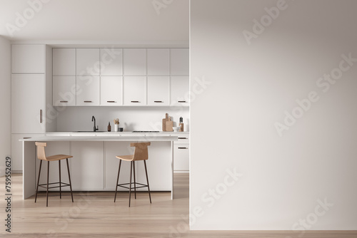 White kitchen interior with island and blank wall