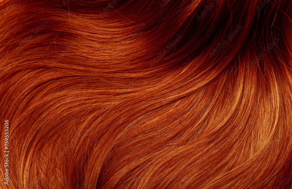 Red hair close-up as a background. Women's long orange hair. Beautifully styled wavy shiny curls. Hair coloring bright shades. Hairdressing procedures, extension. Red hair close-up as a background. Women's long orange hair. Beautifully styled wavy shiny curls. Hair coloring bright shades. Hairdressing procedures, extension.