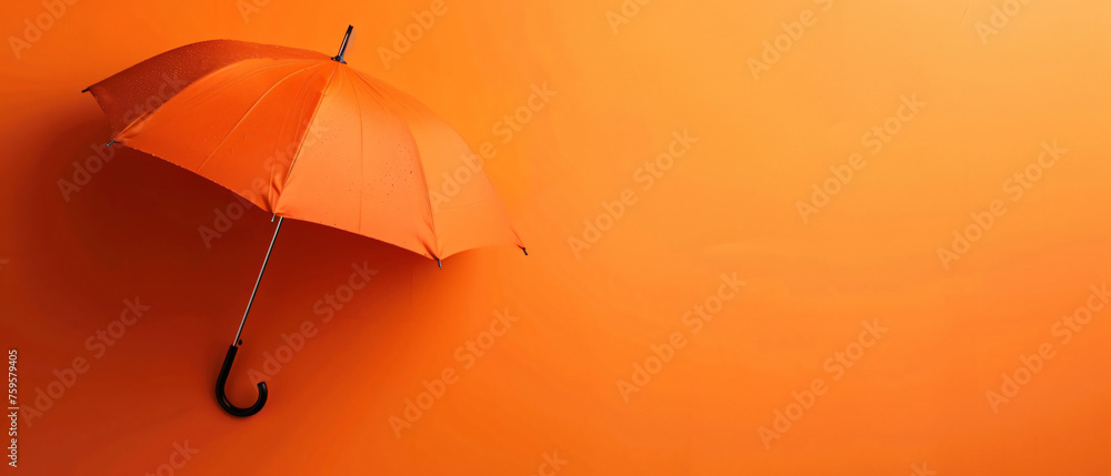 An open umbrella on an orange background 