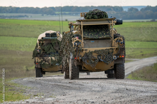 British army Supacat Jackal 4x4 rapid assault, fire support and reconnaissance vehicle, in action on a military exercise, Wilts UK photo