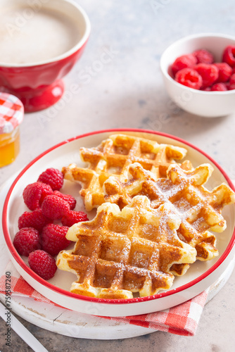 Waffles on a plate with fresh raspberries, selective focus