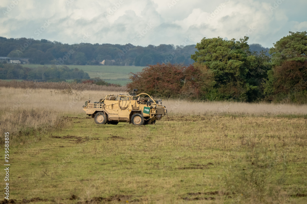 Fototapeta premium close-up of a British army Supacat Jackal 4x4 rapid assault, fire support and reconnaissance vehicle, in action on a military exercise, Wilts UK