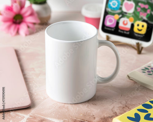 High angle view of a white mug mock-up, placed on a pink table with a smartphone and other decoration for a product shoot.