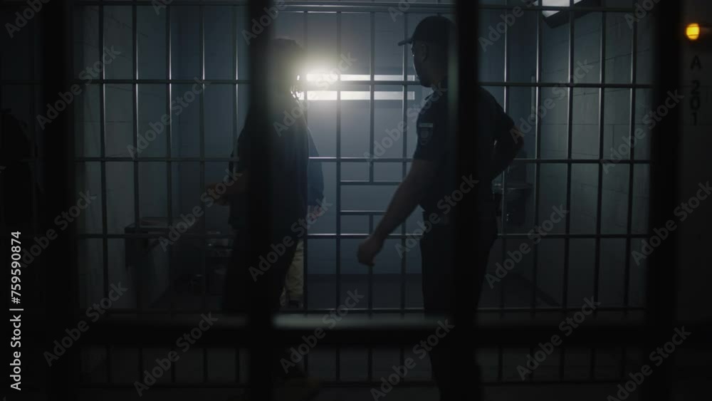 Warden brings new prisoner in jail cell and takes off his handcuffs ...