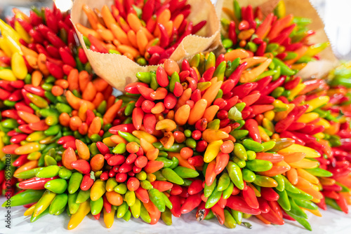 Bunch of colorful chili peppers at the Rialto Bridge market in Venice. Sheaf of colorful chilli peppers. Concept of fresh organic food market. Chilli for sale in market. Colorful chili peppers.