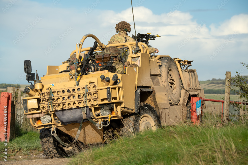 close-up of a British army Supacat Jackal 4x4 rapid assault, fire support and reconnaissance vehicle, in action on a military exercise, Wilts UK close-up of a British army Supacat Jackal 4x4 rapid assault, fire support and reconnaissance vehicle, in action on a military exercise, Wilts UK