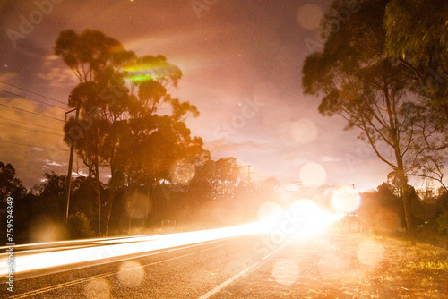 Car light trails and bokeh on stormy night photo
