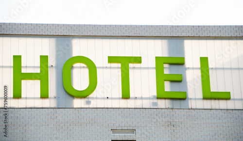 Close-up of hotel word with green letters on hotel