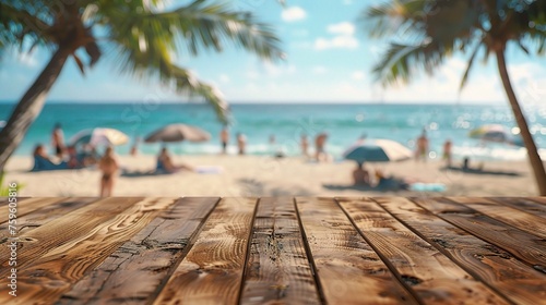 Wood table top on blurred beach background with people in colorful 