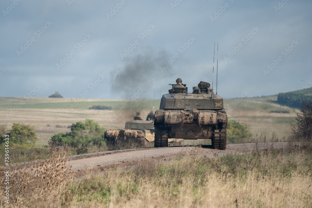 Fototapeta premium Commanders and gunners directing a pair of British army Challenger 2 II FV4034 main battle tanks in action on a military exercise, Wilts UK
