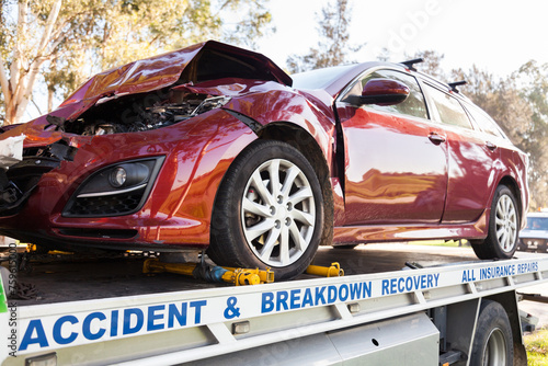 Smashed car after a road accident beside a highway
