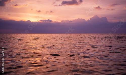 Purple sunset sky on ocean, Scenic sea sunset over calm water surface © Alex