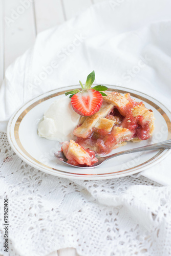 home made pie with rhubarb and strawberry on white background close up selective focus