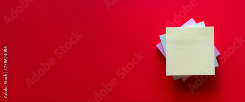 Blank Yellow stickynote on red background with copyspace. photo