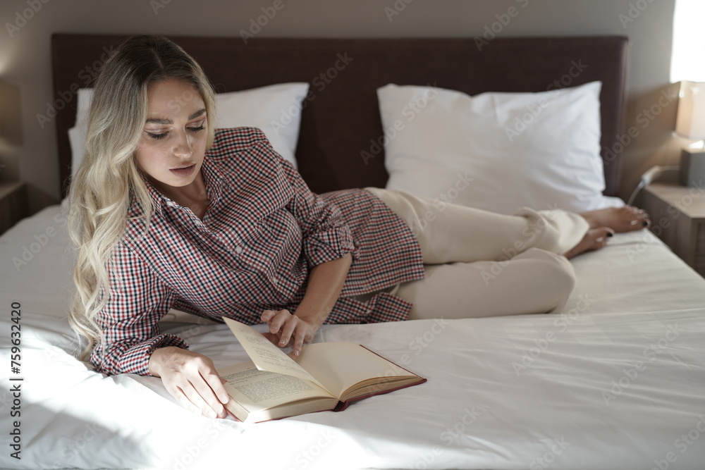 Woman with blond hair and beautiful face reading a book Woman with blond hair and beautiful face reading a book
