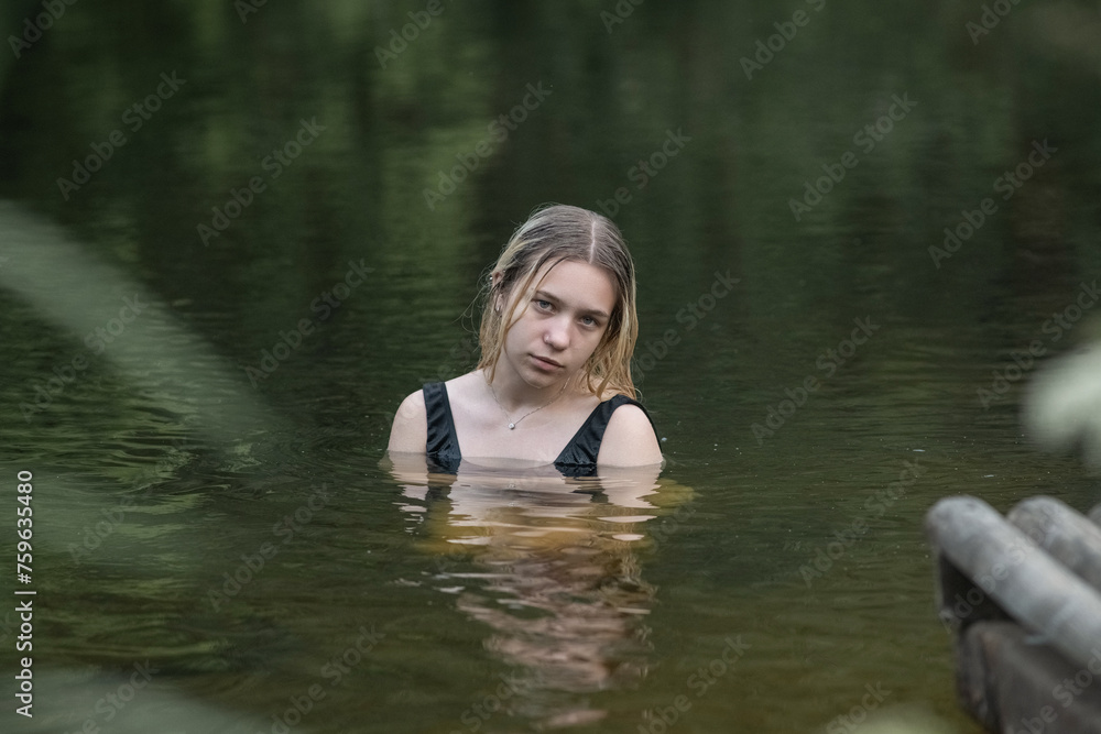 Portrait of a young beautiful blonde girl by the river. Portrait of a young beautiful blonde girl by the river.