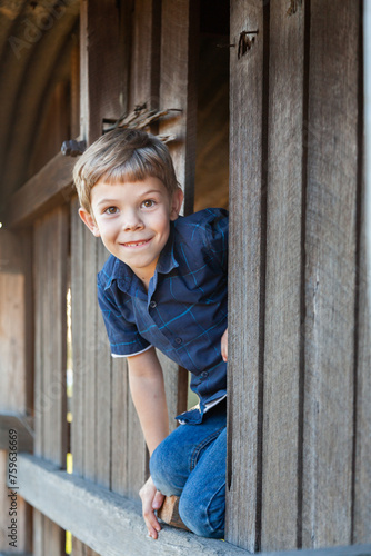 Portrait of a cheeky seven year old boy in rural stetting photo