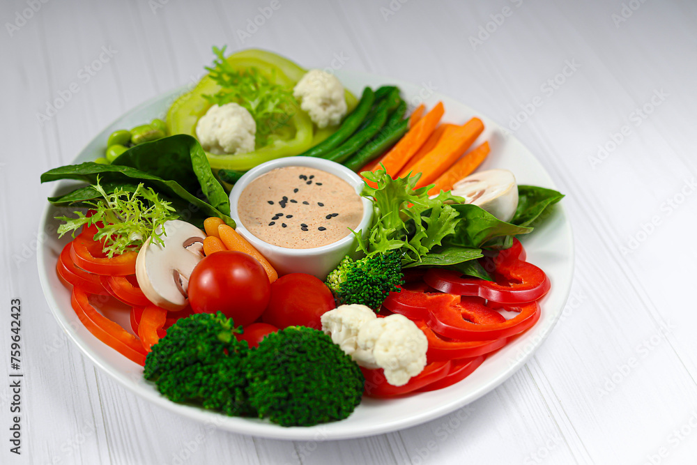 Vegetable salad of tomatoes carrots, bell peppers with sauce Diet food Keto diet Vegetable salad of tomatoes carrots, bell peppers with sauce Diet food Keto diet