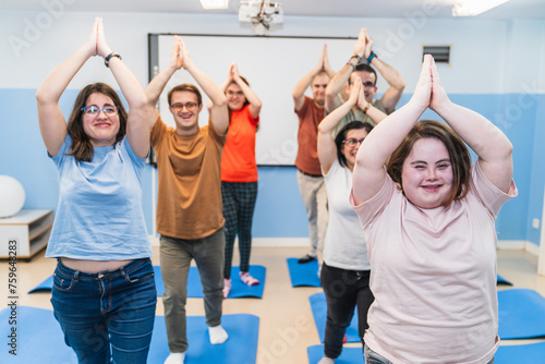 Participants with Down Syndrome lead a joyful yoga class, showcasing inclusivity.