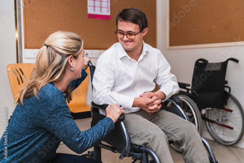 A heartfelt chat between a woman and a smiling man with Down Syndrome in a wheelchair.