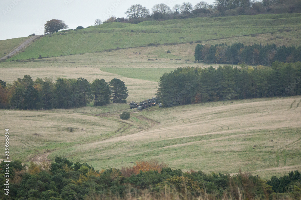 Obraz premium convoy of army trucks moving in the countryside