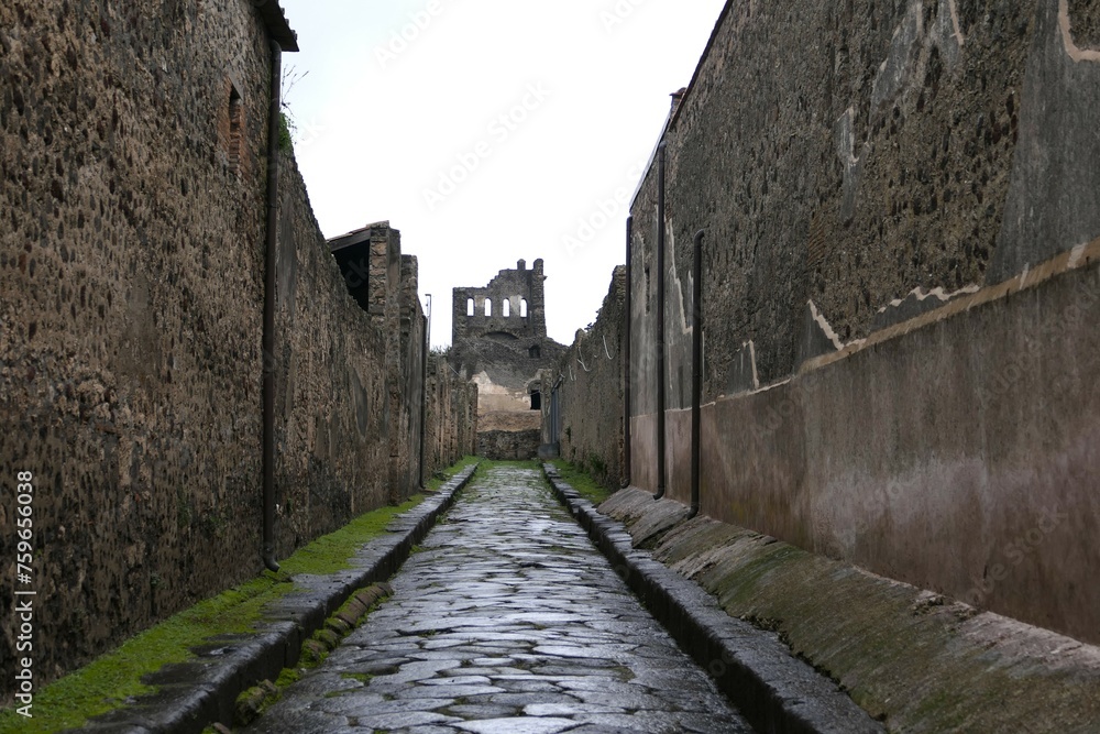 Cobbled streets of the city of Pompeii. Wet streets and cloudy skies. Ancient Roman city buried after the eruption of the Vesuvius volcano in 79AD