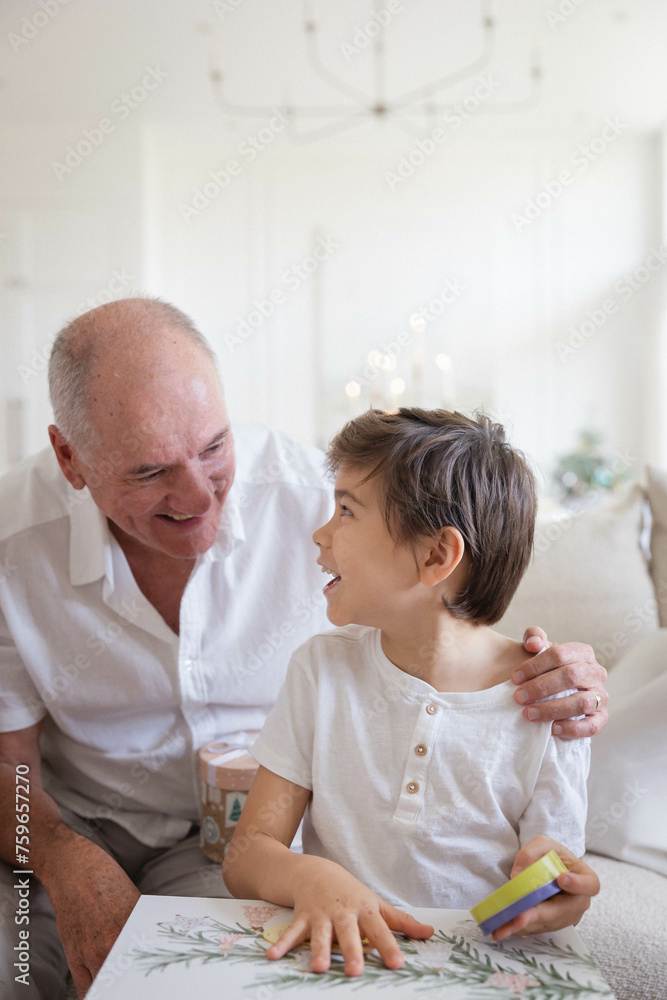 Grandad with grandson opening Christmas present Grandad with grandson opening Christmas present