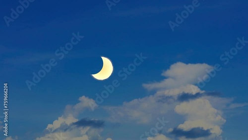 Total solar eclipse and heap white cloud clear blue sky huge rollong time lapse