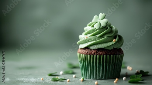 Patrick's Day cupcake with green frosting and a clover on a green background