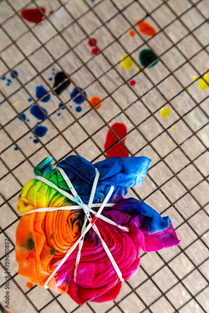 Colourful tie-dye spiral drying on a wire rack. Colourful tie-dye spiral drying on a wire rack.